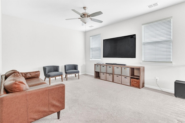 carpeted living room with ceiling fan