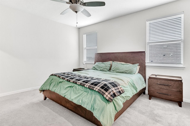 bedroom featuring light colored carpet and ceiling fan