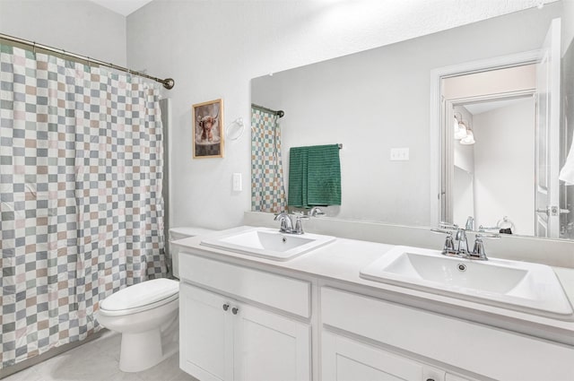 bathroom with tile patterned flooring, vanity, and toilet