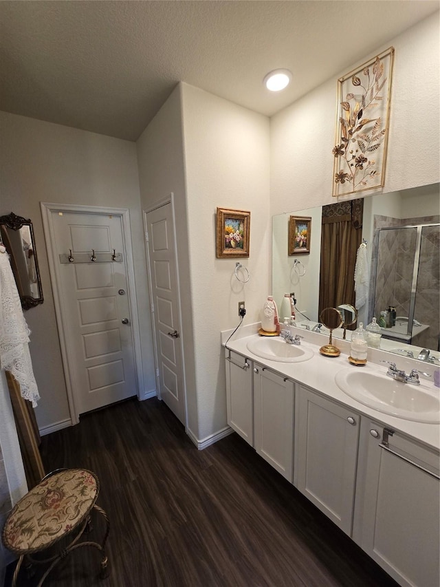 bathroom featuring vanity, hardwood / wood-style floors, and walk in shower