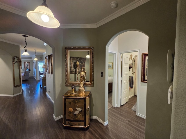 hall with dark wood-type flooring and ornamental molding