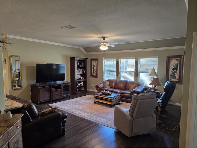 living room with dark wood-type flooring, ceiling fan, ornamental molding, and a textured ceiling