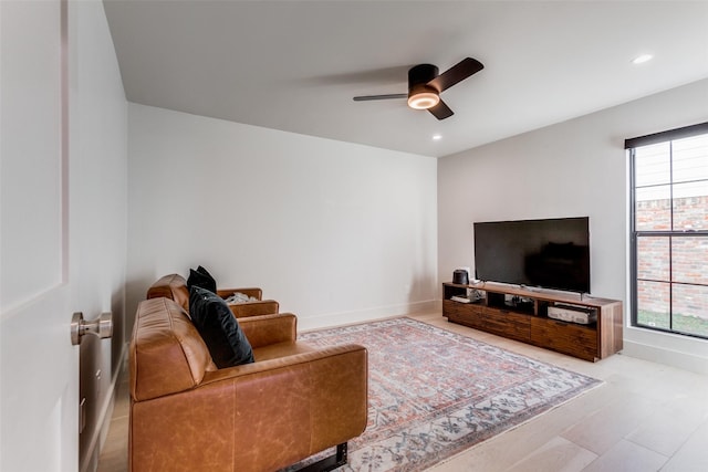 living room with ceiling fan, a healthy amount of sunlight, and light hardwood / wood-style floors