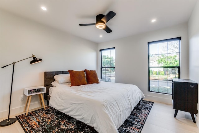 bedroom featuring light wood-type flooring and ceiling fan