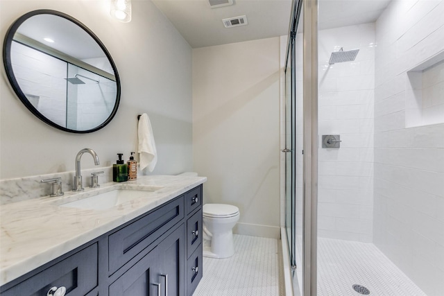 bathroom featuring toilet, an enclosed shower, and vanity