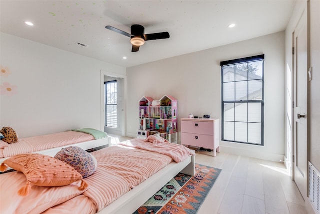 bedroom with light hardwood / wood-style flooring and ceiling fan