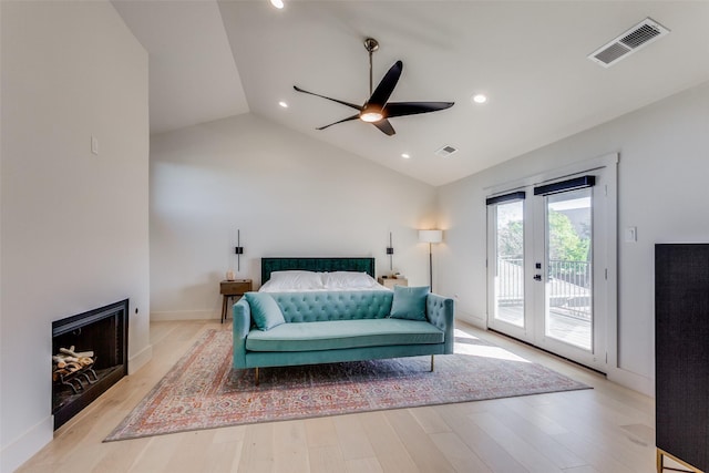 bedroom featuring ceiling fan, french doors, light hardwood / wood-style floors, vaulted ceiling, and access to outside