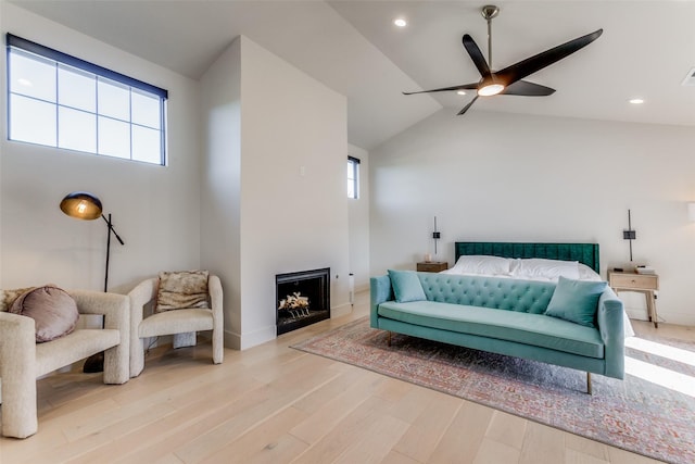 bedroom with ceiling fan, light hardwood / wood-style floors, and high vaulted ceiling