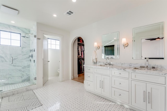 bathroom with tile patterned flooring, vanity, toilet, and a shower with shower door