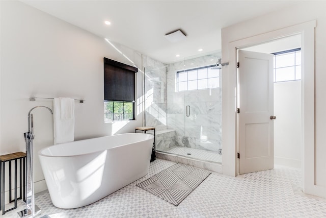 bathroom featuring shower with separate bathtub