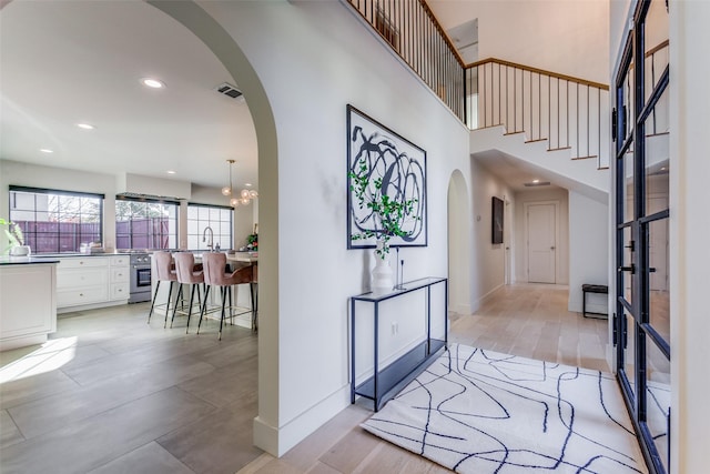 entryway with a chandelier, light hardwood / wood-style floors, and sink