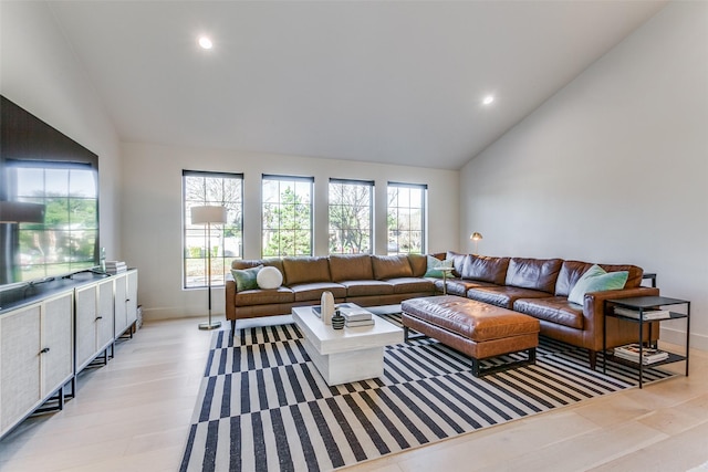 living room featuring light hardwood / wood-style floors and vaulted ceiling