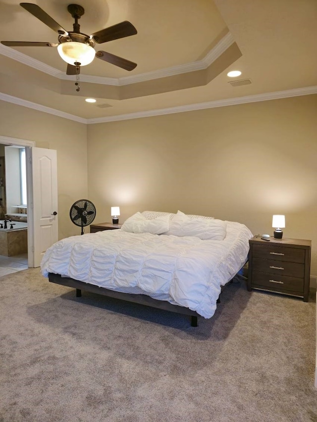 carpeted bedroom featuring a tray ceiling, ceiling fan, and crown molding