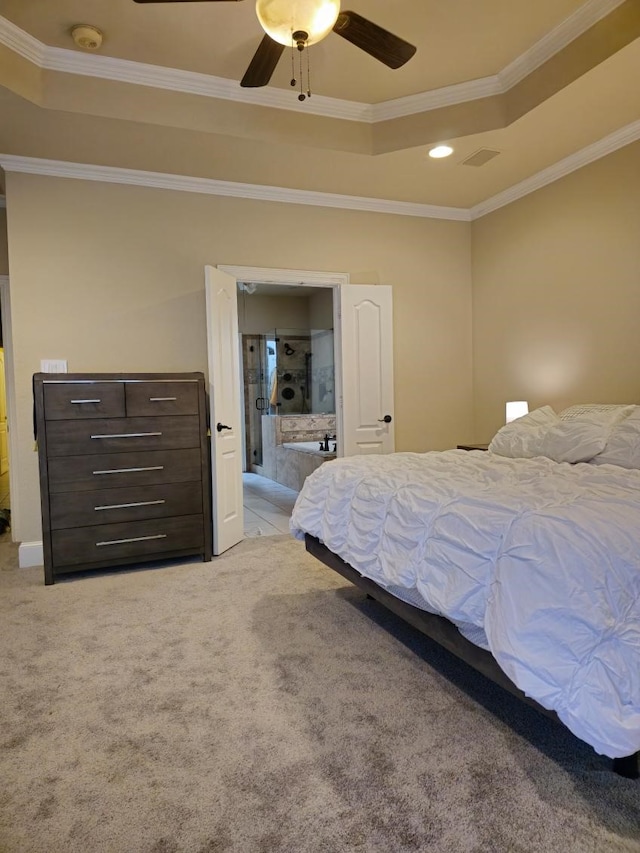 bedroom with ornamental molding, light carpet, ceiling fan, and a tray ceiling