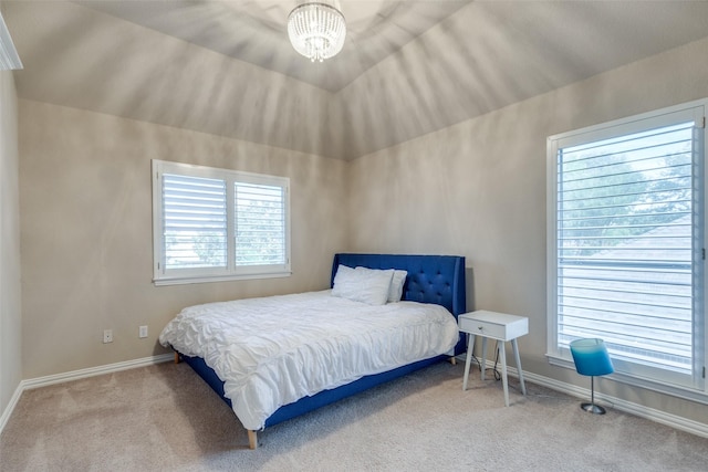 carpeted bedroom with a chandelier