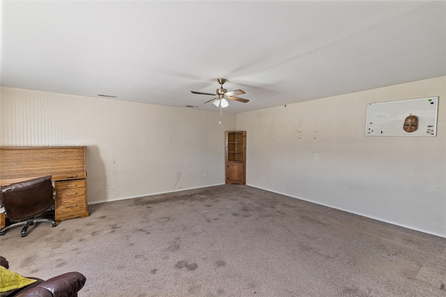 interior space featuring ceiling fan and carpet floors