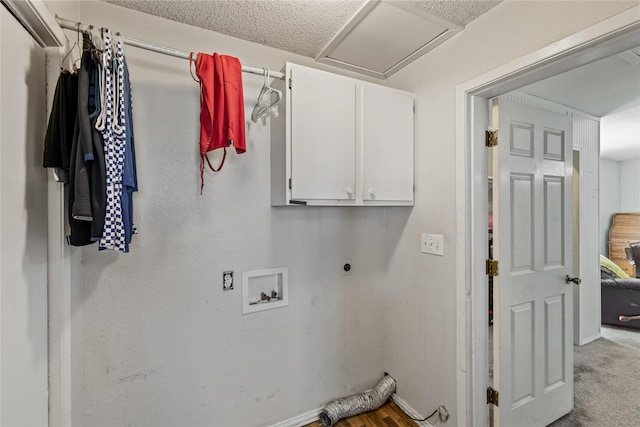 washroom with washer hookup, electric dryer hookup, and cabinets