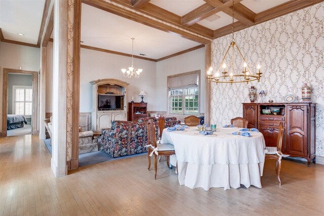 dining space featuring ornamental molding, light hardwood / wood-style flooring, coffered ceiling, and beam ceiling