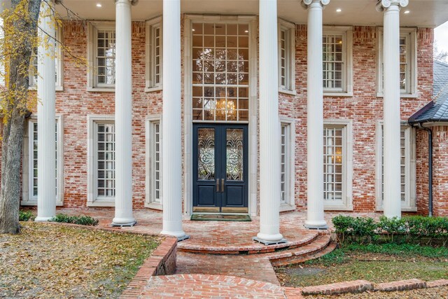 doorway to property with a porch and french doors