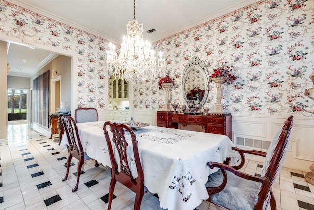 tiled dining room featuring a notable chandelier and ornamental molding