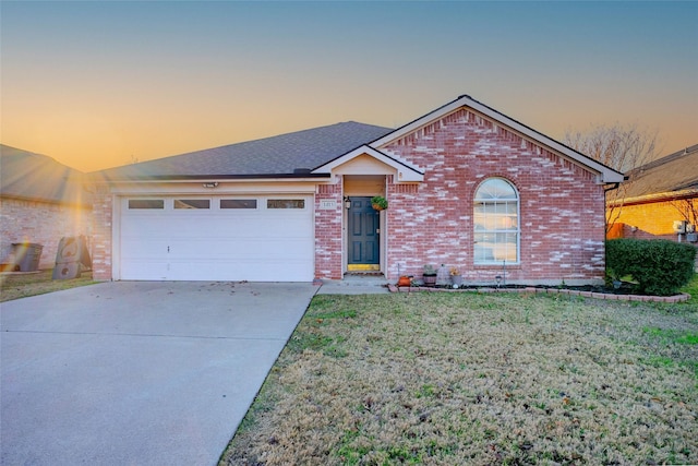 view of front of home with a lawn and a garage