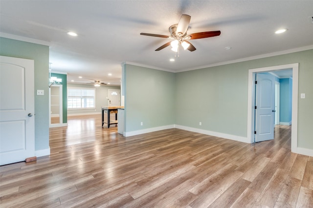 unfurnished room with ceiling fan with notable chandelier, ornamental molding, and light hardwood / wood-style flooring