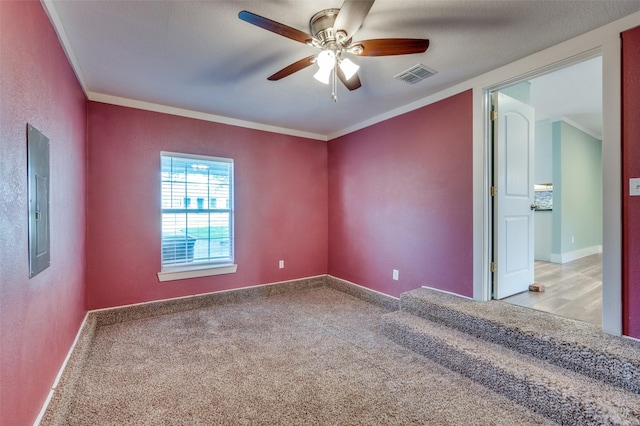 carpeted empty room with electric panel, ceiling fan, and ornamental molding