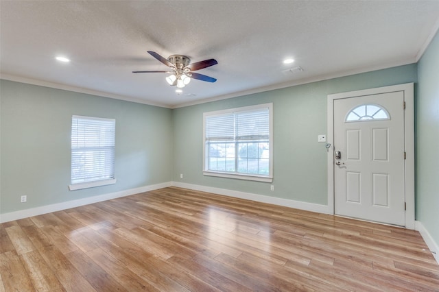 foyer entrance with ceiling fan, light hardwood / wood-style floors, and ornamental molding