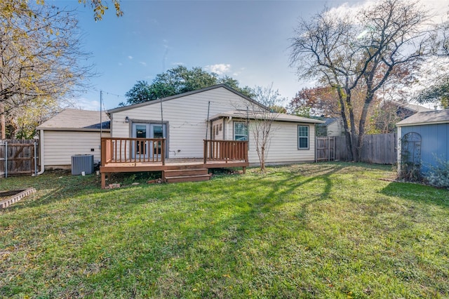 back of house featuring a yard, central AC unit, and a deck