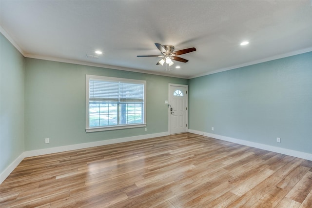 interior space featuring ceiling fan, ornamental molding, and light wood-type flooring