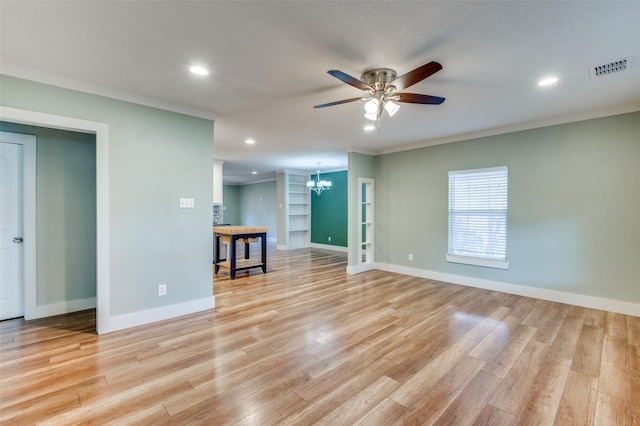 empty room with light hardwood / wood-style floors, ceiling fan with notable chandelier, and ornamental molding