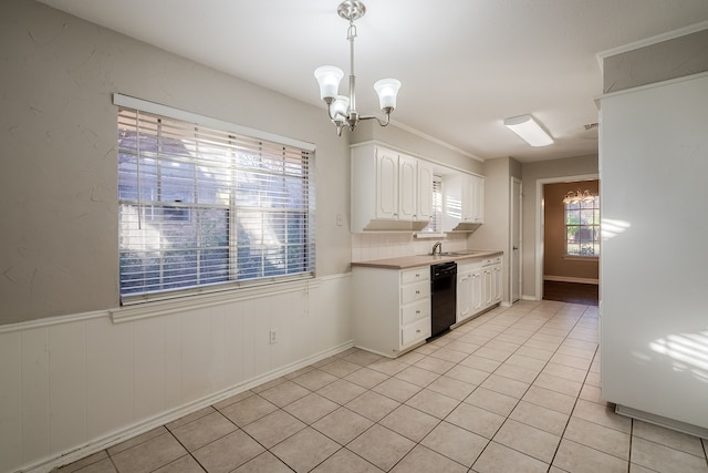 kitchen featuring light tile patterned floors, black dishwasher, a notable chandelier, decorative light fixtures, and white cabinets