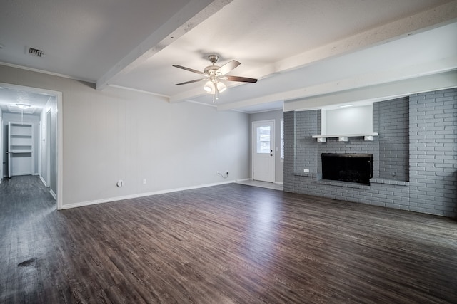 unfurnished living room featuring beam ceiling, ceiling fan, a fireplace, and dark hardwood / wood-style floors