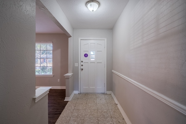 doorway featuring a textured ceiling