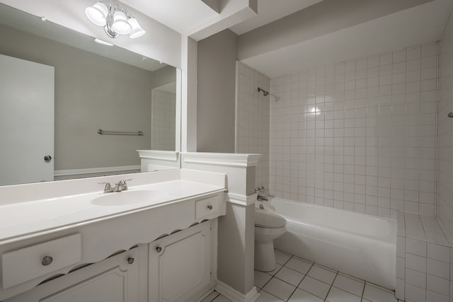 full bathroom featuring tile patterned flooring, vanity, tiled shower / bath combo, and toilet