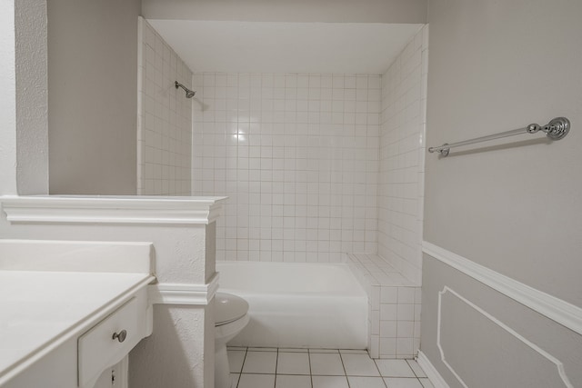 full bathroom featuring tile patterned flooring, vanity, toilet, and tiled shower / bath