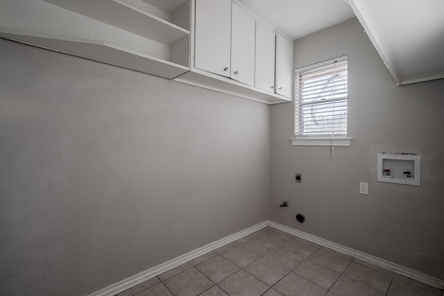 laundry area with washer hookup, electric dryer hookup, cabinets, and light tile patterned floors