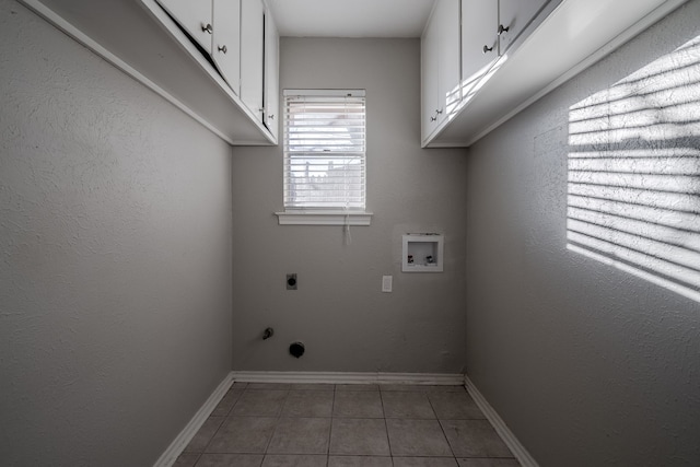 laundry room featuring tile patterned floors, hookup for a washing machine, cabinets, and hookup for an electric dryer