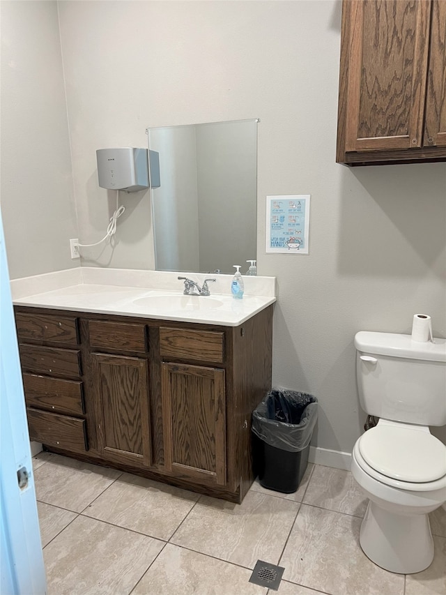 bathroom featuring vanity, tile patterned floors, and toilet