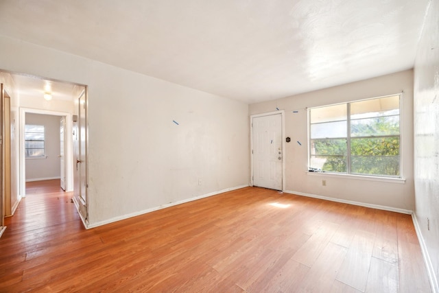 unfurnished room with light hardwood / wood-style flooring