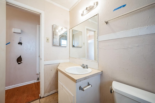 bathroom with tile patterned flooring, vanity, and toilet