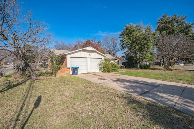 view of side of property with a yard and a garage