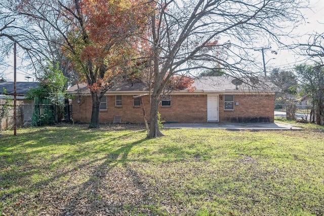 back of property featuring a patio area and a lawn