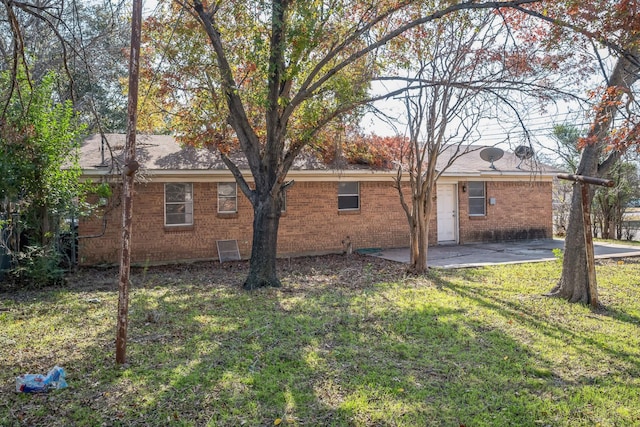 back of property with a patio area and a lawn