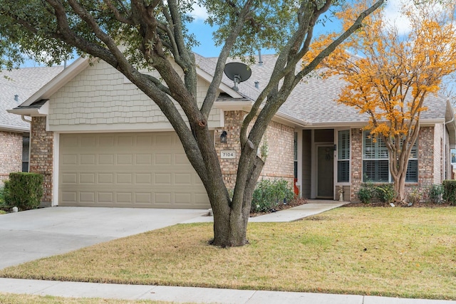 view of front of home with a garage and a front lawn