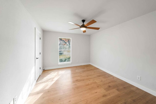 unfurnished room featuring light wood-style floors, baseboards, and a ceiling fan