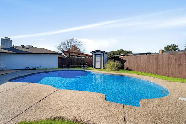 view of swimming pool with a shed, an outdoor structure, a fenced backyard, and a fenced in pool