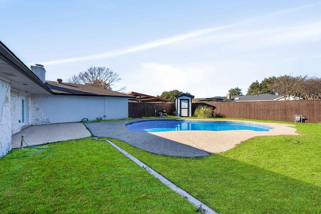 view of pool with a shed, a fenced backyard, a fenced in pool, and an outbuilding