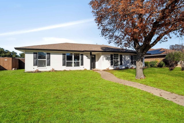 ranch-style house with brick siding, a front yard, and fence