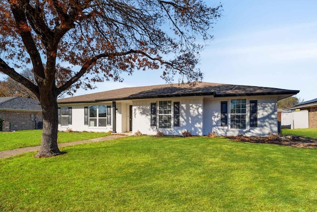 ranch-style home with a front lawn and brick siding